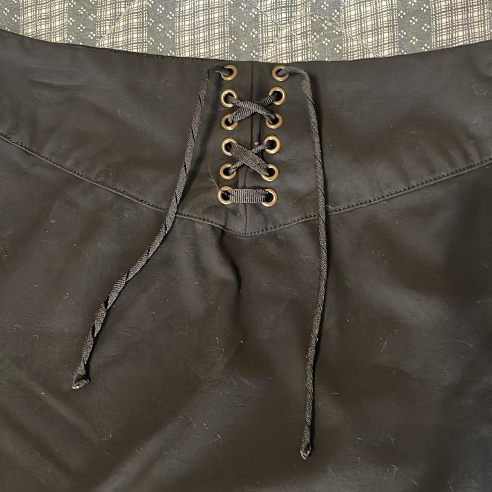 Women’s size 6, black pencil skirt stretchy. Lattice lace up. Hidden side zipper